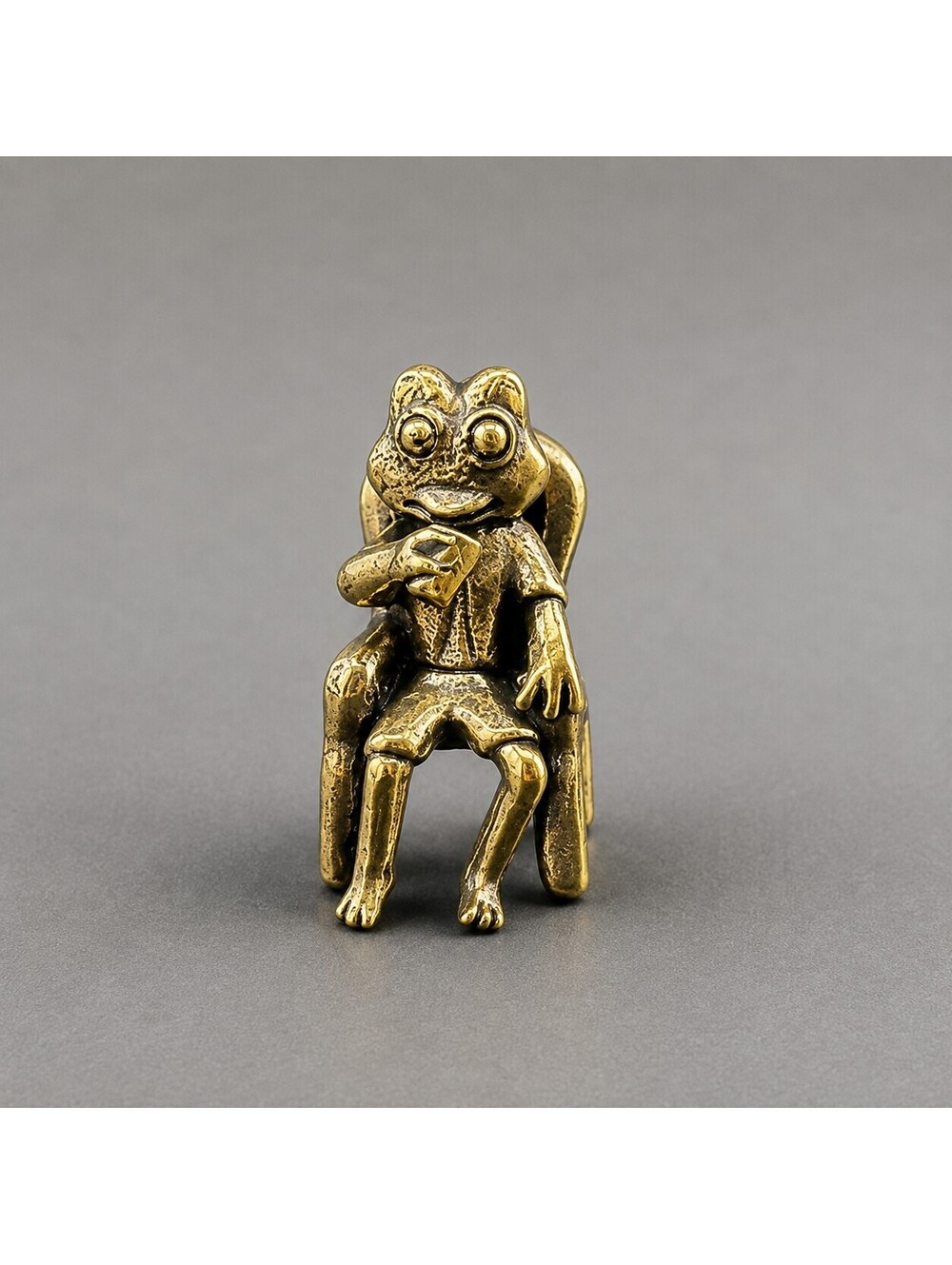 Vintage-Style Frog Figurine Sitting on Chair Holding Cup